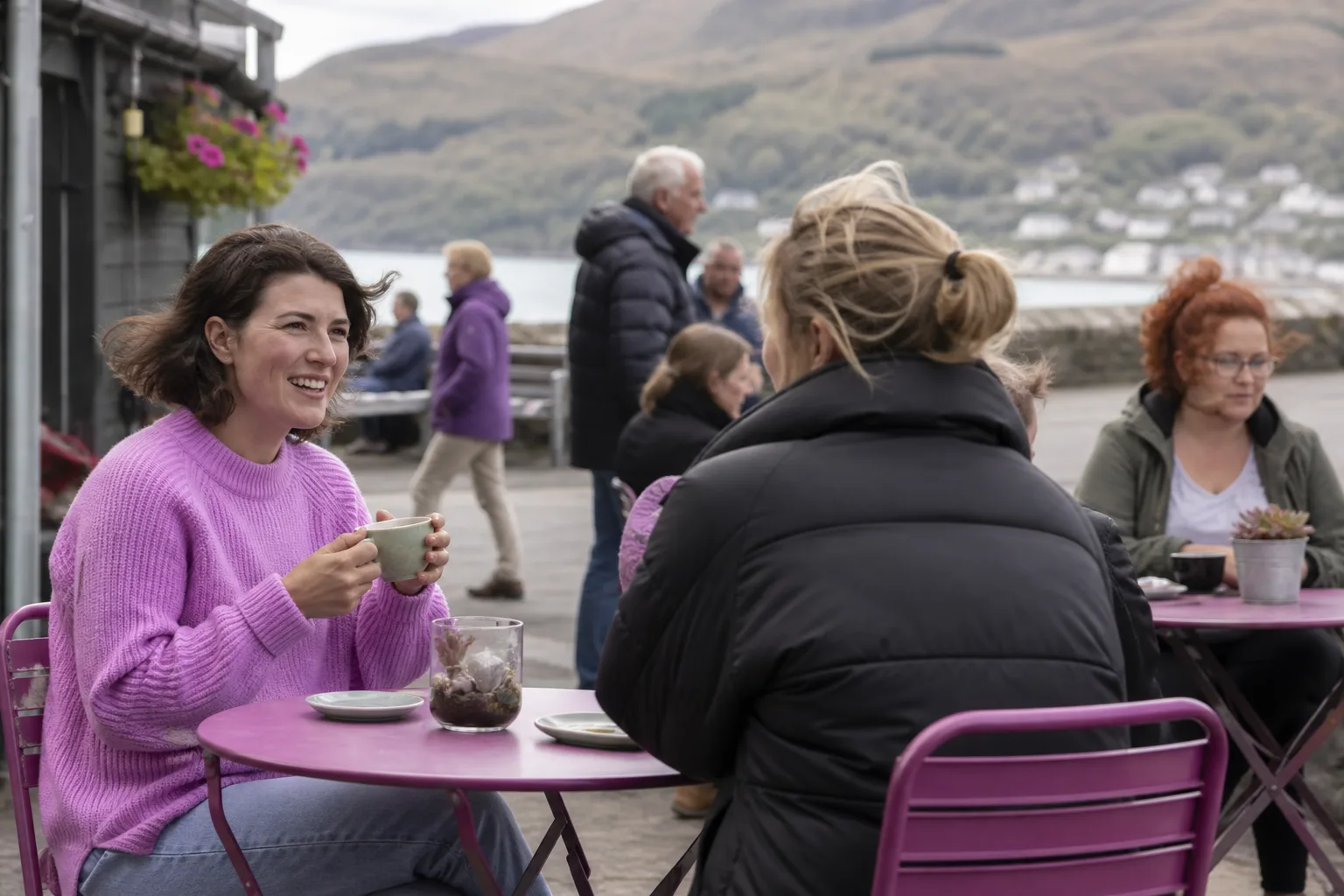 Two people talking over coffee in a quiet Gwynedd café